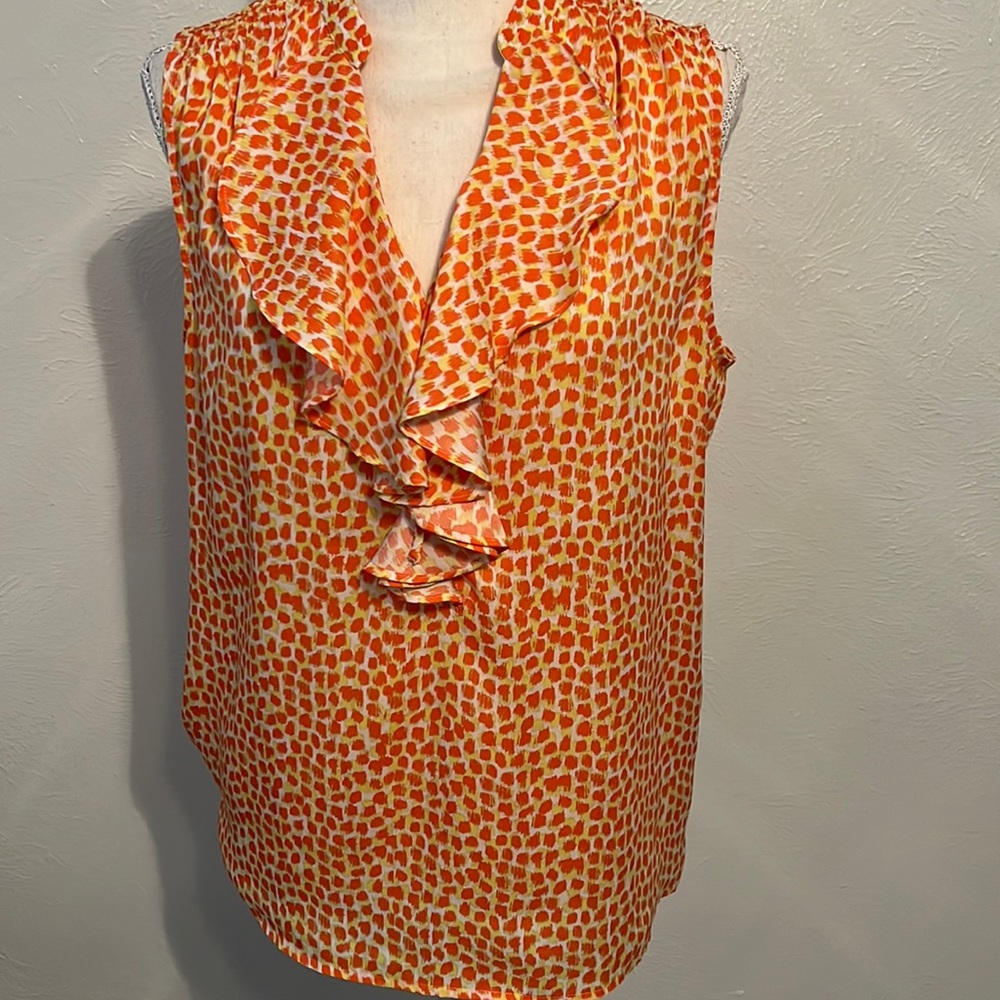 Sleeveless blouse with ruffle detail.  Orange/yellow print.  Shirred shoulder